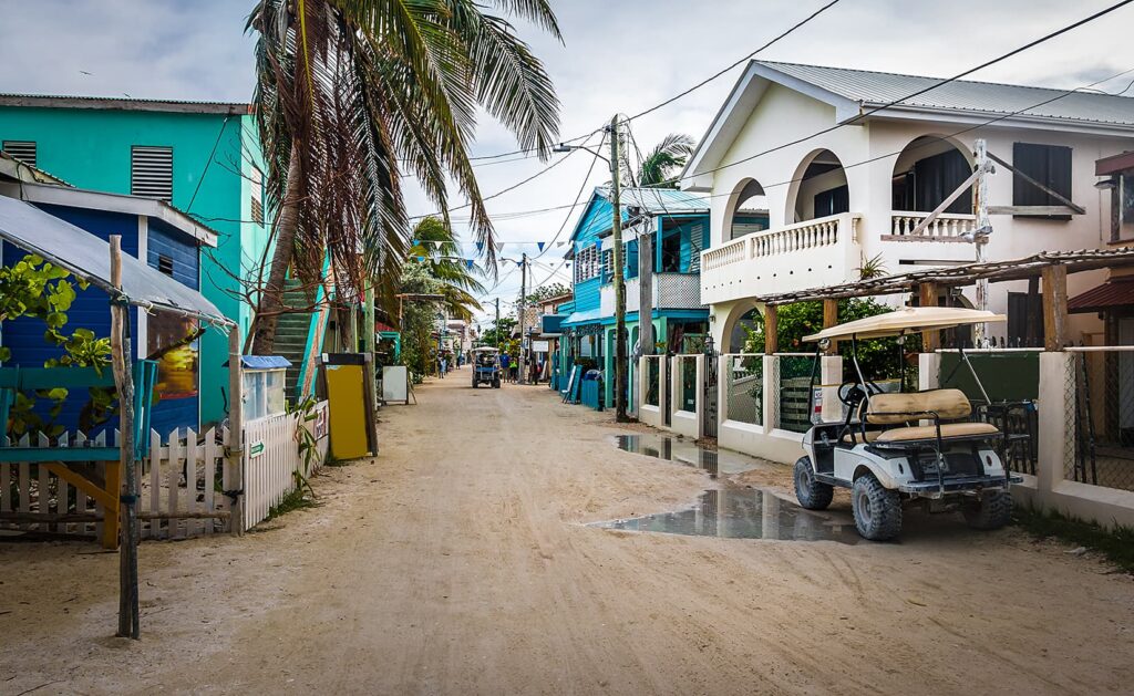 Sandy street in belize overlooking buildings