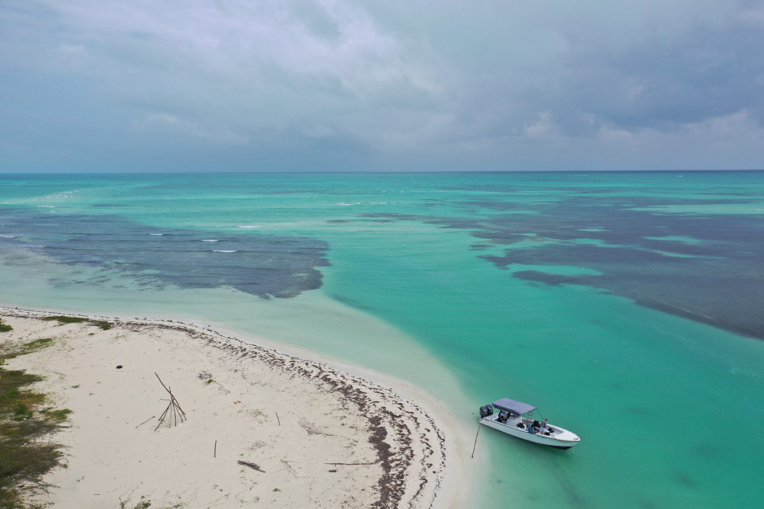 aerial photo of belize reef with boat moored